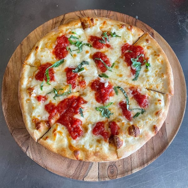 Sonia's Gourmet Kitchen's Italian pizza, topped with rich red sauce, melted cheese, and fresh basil.