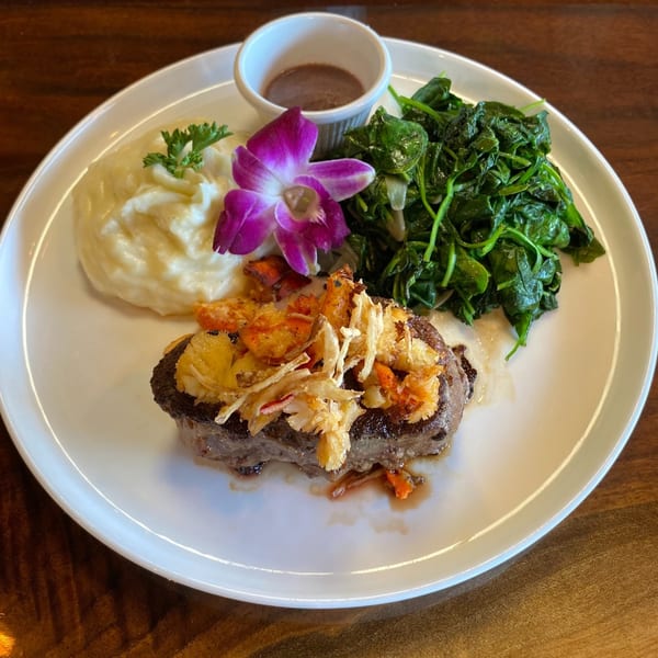 Steak topped with lobster and crispy onions, served with mashed potatoes, spinach, and gravy.